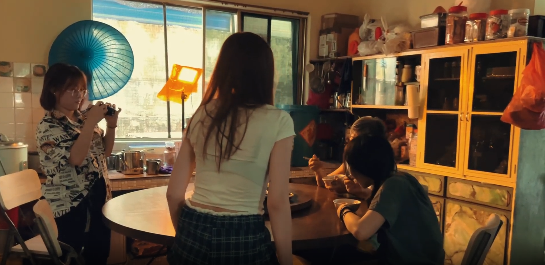 Framed in golden light, a girl and an aunty rehearse, but it already feels like home.