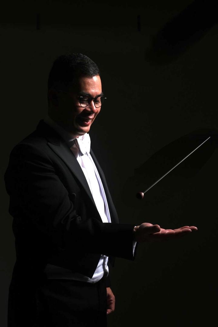 Eric Lee is a distinguished Malaysian conductor and trombonist who has significantly contributed to Malaysia's music scene and beyond. Known for his leadership in forming the PJ Youth Symphonic Band, the Philharmonic Winds of Malaysia, and the National Band Director Association of Malaysia, Eric has been pivotal in nurturing young musical talent and promoting symphonic music in Malaysia and Southeast Asia. Born in Malaysia, Eric developed an early interest in music, particularly the trombone. His initial music education laid a strong foundation for his future endeavors. His passion and dedication to music were evident from a young age, leading him to pursue advanced studies and professional development. In 1994, Eric founded the PJ Youth Symphonic Band, providing a platform for young musicians to develop their skills. This initiative was followed by establishing the Philharmonic Winds of Malaysia, formerly known as the Symphonic Winds of the National Symphony Orchestra. Under his direction, these ensembles have achieved critical acclaim and have played a vital role in the cultural landscape of Malaysia. In 1997, Eric received a full scholarship to study trombone at the Hong Kong Academy for Performing Arts (HKAPA). During his time in Hong Kong, he participated in master classes with prominent figures such as the American Horn Quartet, Luur Metals, Spanish Brass Quintet, Roger Bobo, and James Da Sanol. He also studied with renowned trombonists like John Swallow, Scott Hartman, and Jan Mortensen, and conducted with Mark Shanahan. From 1996, Eric was selected to represent Malaysia in the Asian Youth Orchestra (AYO) for six consecutive years. As a member of AYO, he performed in over 40 cities across 20 countries, including prestigious venues like the Royal Concertgebouw and the Sydney Opera House. He had the opportunity to perform under esteemed conductors and with renowned artists such as Yo-Yo Ma and Mischa Maisky. Eric made his conducting debut in 1999 with the Kuala Lumpur Symphony Orchestra for the production of Eric Lee is a distinguished Malaysian conductor and trombonist who has significantly contributed to Malaysia's music scene and beyond. Known for his leadership in forming the PJ Youth Symphonic Band, the Philharmonic Winds of Malaysia, and the National Band Director Association of Malaysia, Eric has been pivotal in nurturing young musical talent and promoting symphonic music in Malaysia and Southeast Asia. Born in Malaysia, Eric developed an early interest in music, particularly the trombone. His initial music education laid a strong foundation for his future endeavors. His passion and dedication to music were evident from a young age, leading him to pursue advanced studies and professional development. In 1994, Eric founded the PJ Youth Symphonic Band, providing a platform for young musicians to develop their skills. This initiative was followed by establishing the Philharmonic Winds of Malaysia, formerly known as the Symphonic Winds of the National Symphony Orchestra. Under his direction, these ensembles have achieved critical acclaim and have played a vital role in the cultural landscape of Malaysia. In 1997, Eric received a full scholarship to study trombone at the Hong Kong Academy for Performing Arts (HKAPA). During his time in Hong Kong, he participated in master classes with prominent figures such as the American Horn Quartet, Luur Metals, Spanish Brass Quintet, Roger Bobo, and James Da Sanol. He also studied with renowned trombonists like John Swallow, Scott Hartman, and Jan Mortensen, and conducted with Mark Shanahan. From 1996, Eric was selected to represent Malaysia in the Asian Youth Orchestra (AYO) for six consecutive years. As a member of AYO, he performed in over 40 cities across 20 countries, including prestigious venues like the Royal Concertgebouw and the Sydney Opera House. He had the opportunity to perform under esteemed conductors and with renowned artists such as Yo-Yo Ma and Mischa Maisky. Eric made his conducting debut in 1999 with the Kuala Lumpur Symphony Orchestra for the production of